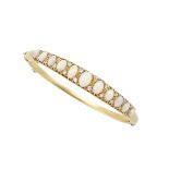 18K YELLOW GOLD HINGED BANGLE set with 11 oval opal cabochons and 20 small old single cut