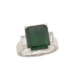 18K WHITE GOLD RING set with an emerald cut emerald (5.52ct.) flanked by 2 small baguette cut