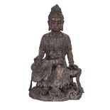 A MASSIVE BRONZE FIGURE OF GUANYIN, QIANLONG MARK, QING DYNASTY 清 銅鎏金坐岩觀音 Seated with one foot