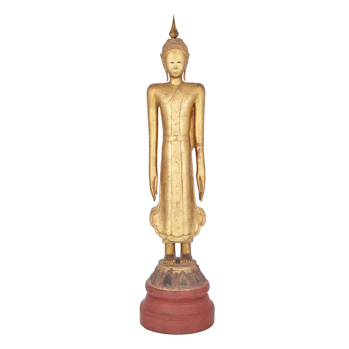 THAI WOODEN AYUTTHAYA STYLE BUDDHA, 19TH CENTURY 泰國 19世紀 大城時代風格 木製漆金立姿佛 Atop a lotus petal base,