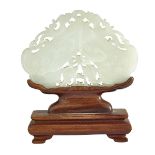 A WHITE JADE PLAQUE WITH A ROSEWOOD STAND, 19TH CENTURY 清19世紀 白玉雙魚龍牌 (配紅木座) Finely articulated in