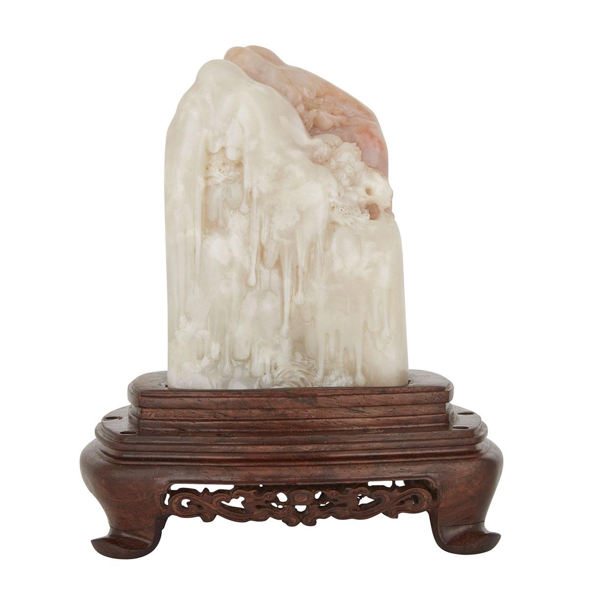 A LARGE AND RARE SHOUSHAN SHANBO STONE WITH A ROSEWOOD STAND 善伯洞石雕山水人物擺件 The creamy pink semi-