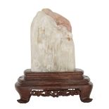 A LARGE AND RARE SHOUSHAN SHANBO STONE WITH A ROSEWOOD STAND 善伯洞石雕山水人物擺件 The creamy pink semi-