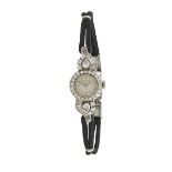 LADY’S MOVADO WRISTWATCH 17 jewel movement; in a platinum case set with 18 baguette cut, 2 pear