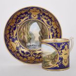 DERBY BLUE AND GILT GROUND IRISH TOPOGRAPHICAL CUP AND SAUCER, C.1810painted in colours with views