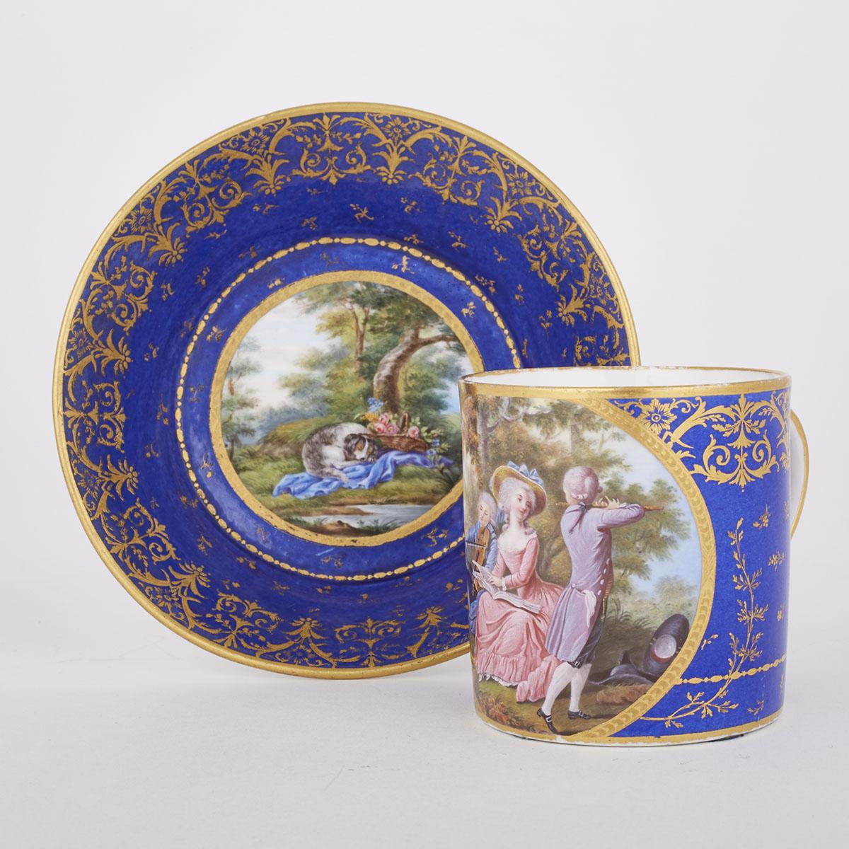 SÈVRES BLUE GROUND COFFEE CAN AND SAUCER, EARLY 19TH CENTURYpainted with panels in colours on