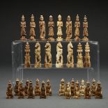 BURMESE CARVED AND POLISHED BONE FIGURAL CHESS SET, 19TH CENTURYone side stained brown, the