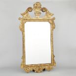 GEORGE II GILTWOOD MIRROR, C.1740the rectangular plate in a conforming frame with foliate and