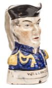 A 19th century Toby jug in the form of the head and shoulders, Duke of Wellington, in blue headdress
