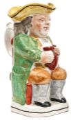A Staffordshire Toby Jug of traditional form, holding an ale jug, handle on reverse 9” high. GC