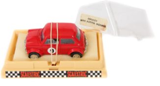 A scarce 1970’s French Scalextric Austin-Morris Mini racing car (090007). In bright red with black