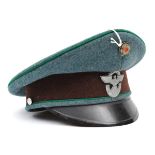 A Third Reich Police officer’s peaked cap, of green felt with apple green piping, brown band,