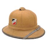 A Third Reich Afrika Korps tan canvas covered pith helmet, with aluminium shields bearing national