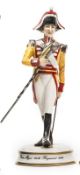 A small scale “Michael Sutty Porcelain Manufactory” figure of a “Drum Major 34th Regiment, 1811”, in