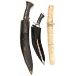 2 bazaar kukris, one in leather sheath, the other velvet covered; a Japanese dagger, carved panelled