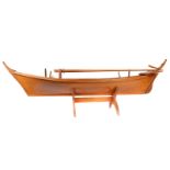 A fine wooden model of a Thai long boat. 112cm overall length, beam of 25cm, from keel to top of