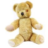 A 1960’s Farnell ‘Jeremy’ Teddy Bear. An example in a bright gold plush, jointed arms and legs