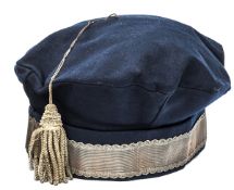 A Georgian cavalry officer’s blue cloth tent cap, wavy edged plain gilt lace headband, bullion
