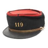 †A French officer’s kepi, probably WWI period, blue cloth with red top, PL peak, gilt chinstrap with