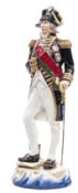 A Michael Sutty large painted porcelain figure “Lord Nelson 1805” in full dress with bicorne hat,