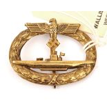 A Third Reich U boat badge of hollow die struck gilt brass with thin vertical pin. GC