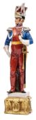 A painted porcelain figure of a Napoleonic Lancer officer, in full dress with sword, 11½” overall.