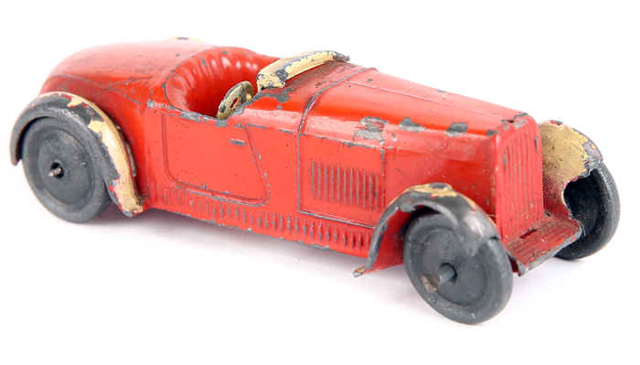 A rare Hornby Series Modelled Miniature Open Sports Car 22a. In orange with cream wheel arches,