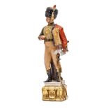 A painted porcelain figure of a Napoleonic Hussar officer, in full dress with busby and pelisse,