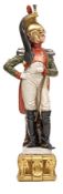 A painted porcelain figure of a Napoleonic Dragoon officer, in full dress with plumed helmet and