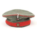 A WWI type Prussian feldmutz, of field grey with red band and piping, and with national and state