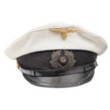 A Third Reich Naval officer’s peaked cap, the ribbed white top with gilt eagle badge, the braided