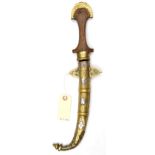 An African jambiya, slender blade 8½”, wooden hilt, brass top, in its brass and WM sheath, simple