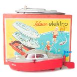 A 1950’s-60’s Schuco elektro 5511/4. A battery powered plastic boat with red hull and two