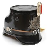 A post war German fibre police shako, the silver plated star badge with arms of Berlin, with oval
