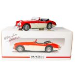 A 1:18 scale Autoart Millennium series Austin Healey 3000. An example in red and cream with wire