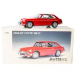 A 1:18 scale Autoart Millennium series MGB GT MK11. In red with black interior, fitted with ‘wire’