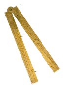 A gunner’s folding brass rule, engraved scales and numerals, length extended 12½”. Good Condition