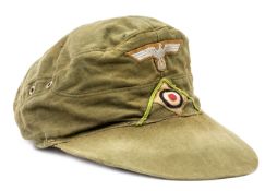 A German Afrikakorps ski cap, green piping on front, red cotton lining with maker’s name stamp and