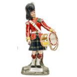 A large Michael Sutty painted porcelain figure of a drummer “Gordon Highlanders” in full dress