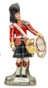 A large Michael Sutty painted porcelain figure of a drummer “Gordon Highlanders” in full dress