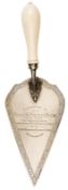 A silver presentation trowel, scrolled border, acanthus mount into ivory handle, the face of the