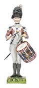 A continental painted porcelain figure “Drummer 1792 First Guards”, in full dress with side drum