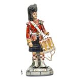 A large Michael Sutty painted porcelain figure of a drummer “Seaforth Highlanders”, in full dress