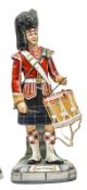 A large Michael Sutty painted porcelain figure of a drummer “Seaforth Highlanders”, in full dress