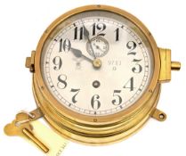 A Thrid Reich Kriegsmarine brass bulkhead clock, the silvered dial with black numerals, and