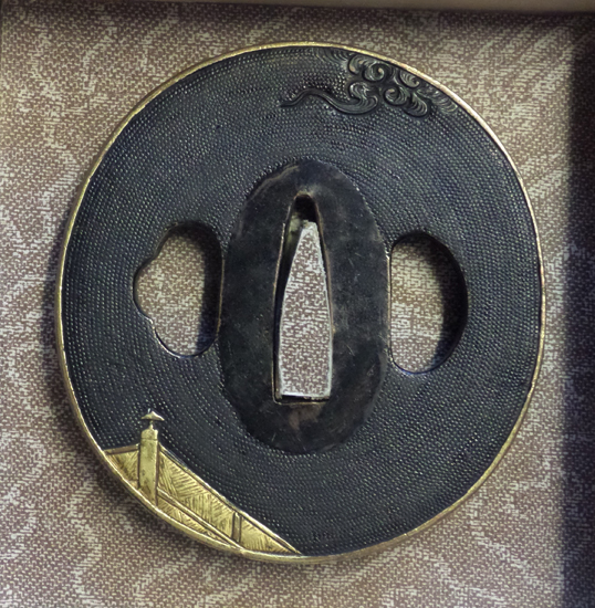 A Shakudo Nanako tsuba, with gilt figures on bridge, in modern box. - Image 2 of 2