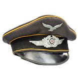 A Third Reich Luftwaffe Flight NCOs peaked cap, with yellow piping and aluminium eagle and