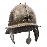 A 17th century “lobster tail” helmet, the ribbed skull formed in two parts, with integral peak,