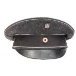 A scarce Third Reich Red Cross officer’s peaked cap, of grey felt with grey band, grey piping, small