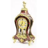 An English 19th Century tortoise shell and gilt brass mantel clock in the Louis XV style, the